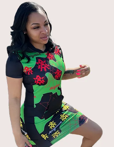 Woman in a green and black Ariyaun print dress