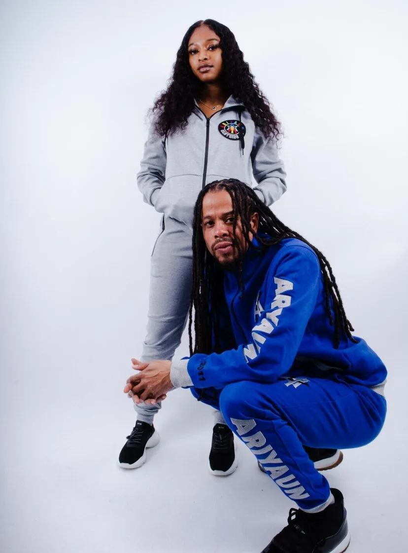 Two models in grey and royal blue Ariyaun tracksuits